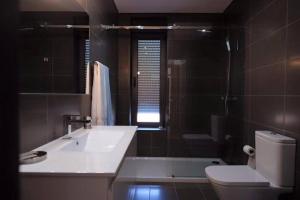 a bathroom with a sink and a toilet and a tub at Luxurious Villa in Vieira do Minho – Private Pool in Vieira do Minho +13 photos