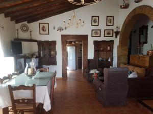 a kitchen and living room with a table and chairs at Charming house in Arriate with private pool. in Arriate