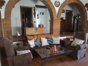 a living room with two couches and a table at Charming house in Arriate with private pool. in Arriate