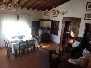 a living room with a dining room table and chairs at Charming house in Arriate with private pool. in Arriate +13 photos