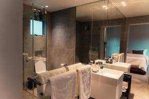 a bathroom with a sink and a mirror at The Pool House in Gqeberha +8 photos