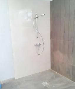 a shower with a glass door in a bathroom at Bright apartment in Almada with shared pool in Almada
