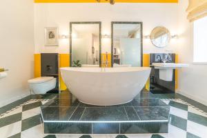 a large bathroom with a tub and a toilet at Comfortable apartment in Bad Schandau – 55 m² with garden terrace in Bad Schandau