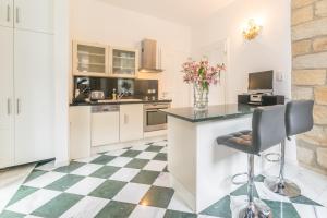 a kitchen with a checkered floor at Comfortable apartment in Bad Schandau – 55 m² with garden terrace in Bad Schandau