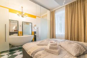 a bedroom with a bed and a tub and a sink at Comfortable apartment in Bad Schandau – 55 m² with garden terrace in Bad Schandau +11 photos