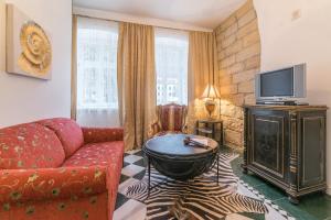 a living room with a couch and a tv at Comfortable apartment in Bad Schandau – 55 m² with garden terrace in Bad Schandau