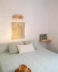a bedroom with a bed with a pillow and a picture at Charming House in El Chaparral in EL Chaparral