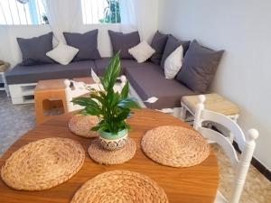 a living room with a table and a couch at Charming House in El Chaparral in EL Chaparral