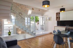 a living room with a glass staircase in a room at Elegant villa in Podgora with private pool and sea view in Podgora +32 photos