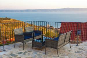 a balcony with chairs and a view of the ocean at Elegant villa in Podgora with private pool and sea view in Podgora