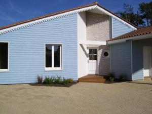 a blue and white house with at Villa ensoleillée à Saint Hilaire de Riez avec piscine privée in Saint-Hilaire-de-Riez