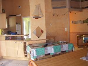 a kitchen with a table with a sail on the wall at Villa ensoleillée à Saint Hilaire de Riez avec piscine privée in Saint-Hilaire-de-Riez