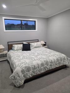 a bedroom with a large bed in a room at Tiatukia Beach House in North Shields