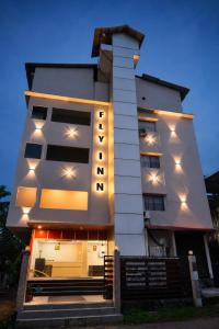 a building with lights on the side of it at Fly Inn in Guwahati