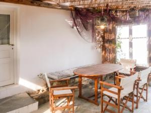 a dining room with a table and chairs at Charming House in Paros, 90 m² with Shared Pool in Parikia