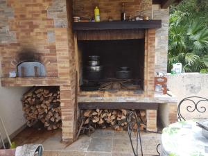 an outdoor brick oven with pots and pans at Villa charmante à Saint-Benoît avec piscine privée in Saint-Benoît