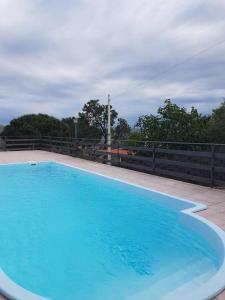 a large blue swimming pool with a fence around it at Beautiful Villa in Caccamo + Pool in Caccamo
