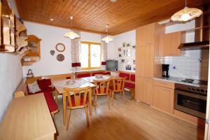 a kitchen and dining room with a table and chairs at Charming House in Pruggern, Mountain View in Pruggern