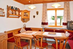 a kitchen and dining room with a table and chairs at Charming House in Pruggern, Mountain View in Pruggern