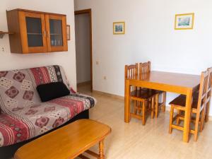 a living room with a couch and a dining room table at Spacious Apartment in Barbate - Terrace with Sea View in Barbate