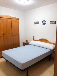 a bedroom with two beds and a wooden cabinet at Spacious Apartment in Barbate - Terrace with Sea View in Barbate +34 photos