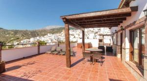a patio with chairs and a table on a balcony at Elegant Villa with Jacuzzi in Canillas de Albaida in Canillas de Albaida +5 photos