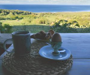 a cup of coffee and a egg on a table at Charming house with sea and mountain views in El Chaparral in EL Chaparral