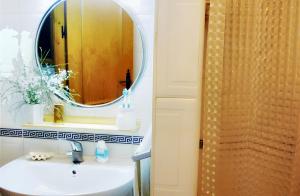 a bathroom with a sink and a mirror at Charming house with sea and mountain views in El Chaparral in EL Chaparral