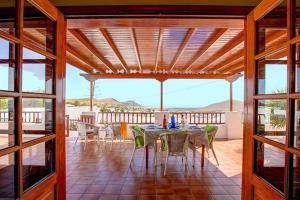 a dining room with a table and chairs on a patio at Modern Villa in Nazaret with Private Pool in Nazaret