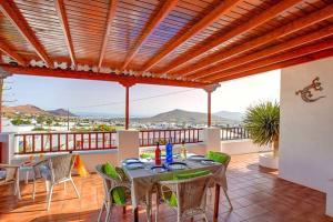 a patio with a table and chairs on a balcony at Modern Villa in Nazaret with Private Pool in Nazaret