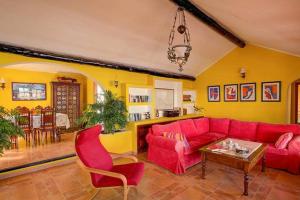 a living room with a red couch and a table at Modern Villa in Nazaret with Private Pool in Nazaret