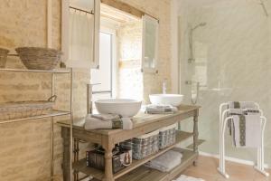 a bathroom with a counter with a sink and a shower at Les loulous in Arrentières +13 photos
