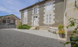a building with a bench in front of it at Les loulous in Arrentières