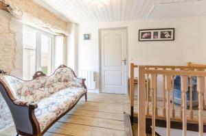 a living room with a couch and a staircase at Les loulous in Arrentières