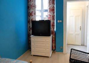 a tv sitting on a dresser in a room at Spacious House in Central Sofia with Garden in Sofia +11 photos