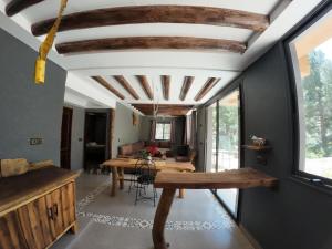 a living room with a wooden table and a ceiling at Ourika Atlas Tigmi in Ourika