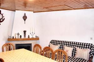 a living room with a couch and a table at Charming House in Paredes do Rio with Mountain View in Paredes do Rio +6 photos