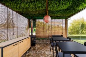a restaurant with tables and chairs and a large window at Penedo Escape Sea Suites in Colares