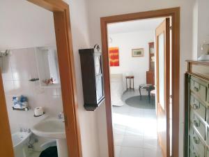 a bathroom with a sink and a toilet and a sink at Charming Apartment in Vibo Valentia with Terrace, 60 m² in Vibo Valentia