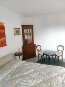 a bedroom with a bed and a table and chairs at Charming Apartment in Vibo Valentia with Terrace, 60 m² in Vibo Valentia