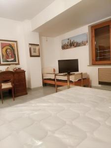 a living room with a large white room with a television at Charming Apartment in Vibo Valentia with Terrace, 60 m² in Vibo Valentia