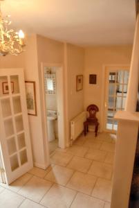 a hallway with a bathroom with a toilet and a sink at Spacious house with sea and mountain views, Co. Kerry in Kells