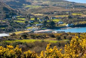 a view of a town with a lake and mountains at Spacious house with sea and mountain views, Co. Kerry in Kells