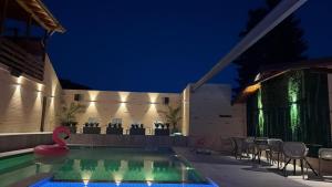 a swimming pool in a house at night at Hanul Marioarei in Buneşti +32 photos