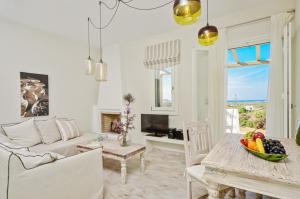a living room with a couch and a table at Spacious house with sea view in Ag. Arsenios, garden in Glinádhon