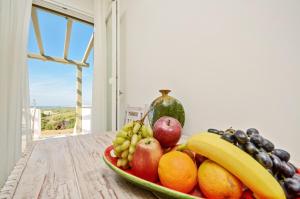 a bowl of fruit on a table with a window at Spacious house with sea view in Ag. Arsenios, garden in Glinádhon