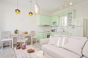 a living room with a couch and a kitchen at Spacious house with sea view in Ag. Arsenios, garden in Glinádhon +33 photos