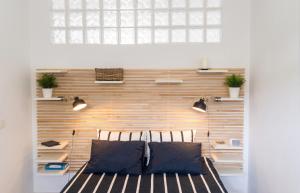 a bedroom with a wooden wall with a bed and two chairs at Charming Apartment in Tías + Pool in Tías