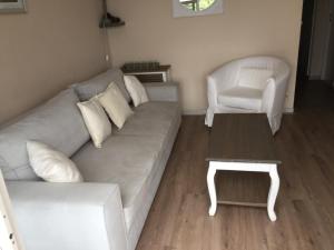 a living room with a couch and a chair at Appartement familial avec vue sur la mer à Agay - 40 m² + piscine in Agay - Saint Raphael