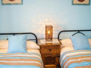 a bedroom with two beds and a table with a lamp at Idyllic House in Yegen with Mountain View in Yegen